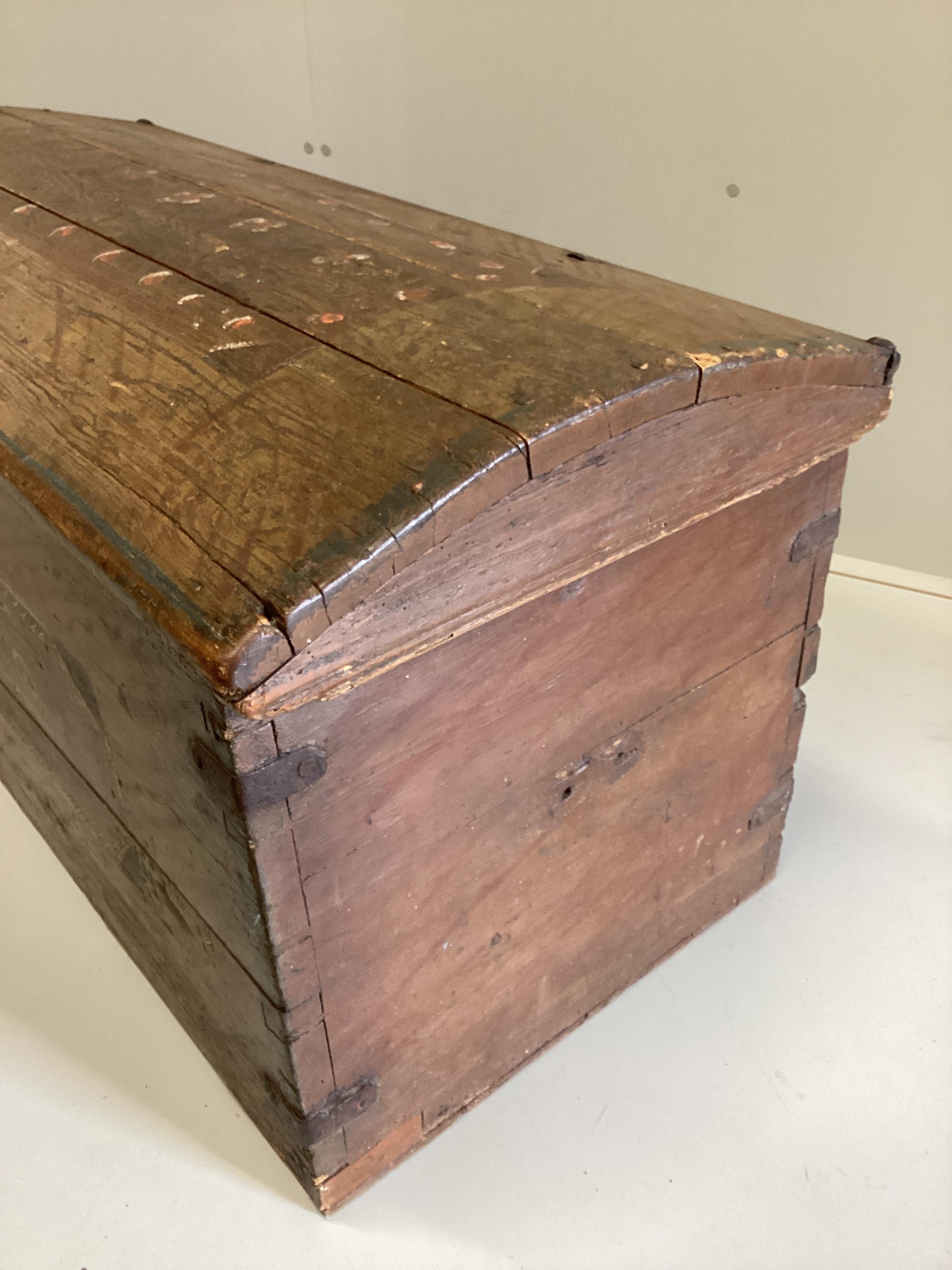 A 19th century pine domed top trunk with painted simulated grain initialled “I.P.D” and dated 1830, width 115cm, depth 53cm, height 56cm.